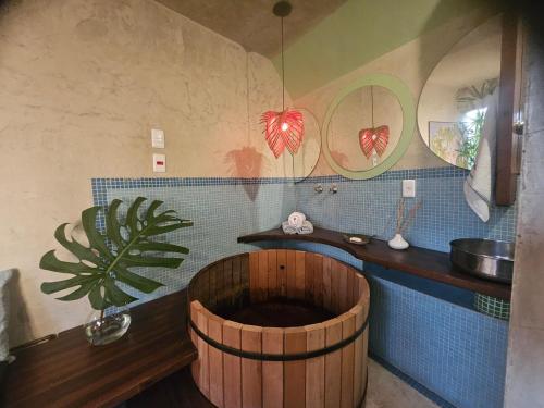 a bathroom with a wooden tub and a sink at Espaço Spa in São Paulo