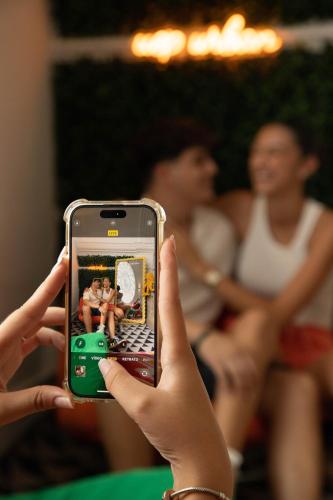 a person taking a picture with a cell phone at Urban Hostel Palma - Albergue Juvenil - Youth Hostel in Palma de Mallorca