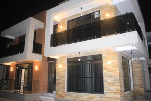 a building with two floors and a balcony at Beach Side Apartment in Gisenyi