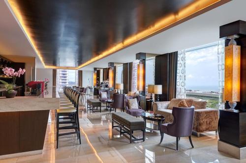 a lobby of a hotel with chairs and a bar at Hatten Hotel Super Sea View 4pax Mid Floor in Melaka