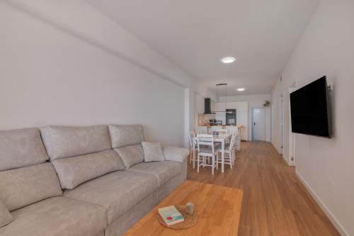 a living room with a couch and a table at Primera Linea en Matalascañas in Matalascañas