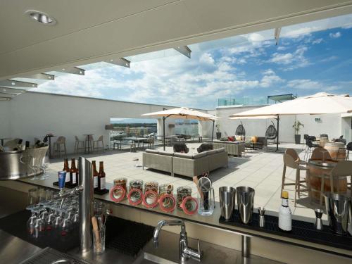 a kitchen and living room with a view of a patio at Mercure Geneva Airport in Geneva