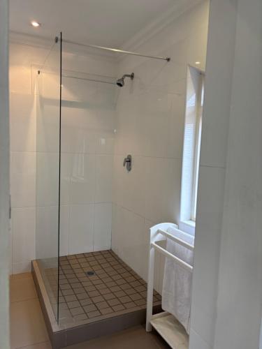 a shower with a glass door in a bathroom at SM Exclusive Accommodation in Durban