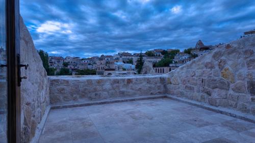 a stone wall with a view of a city at Anjelic Cave Cappadocia in Urgup