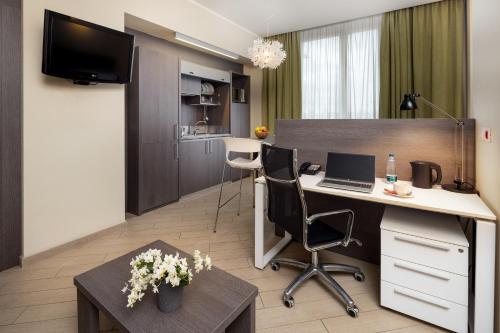 an office with a desk and a computer in a room at CHC Business Residence in Genova