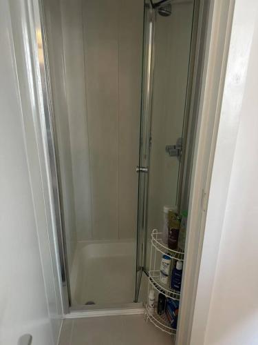 a shower with a glass door in a bathroom at Mulligan Hotel in Dublin
