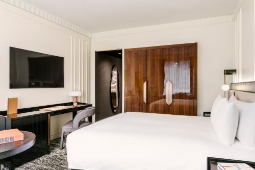 a hotel room with a bed and a desk at Sofitel New York in New York