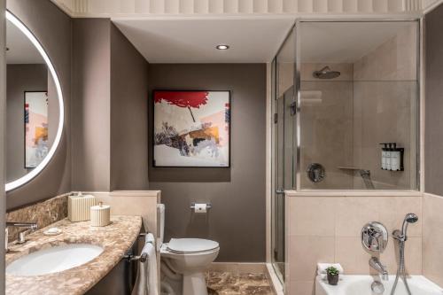 a bathroom with a toilet and a shower and a sink at Sofitel New York in New York