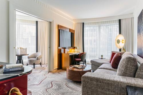 a living room with a couch and a table at Sofitel New York in New York