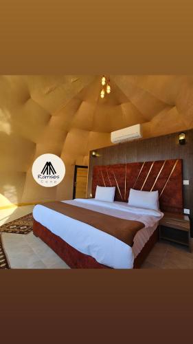 a bedroom with a large bed with a wooden ceiling at Ramses luxury rum camp in Wadi Rum
