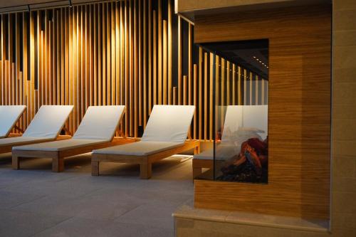 a row of white chairs in a waiting room at Rikli Balance Hotel – Sava Hotels & Resorts in Bled