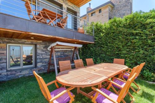 a wooden table and chairs on a yard at Lumber's 3-Bedroom House with Garden in Bakish in Qanāt Bakīsh