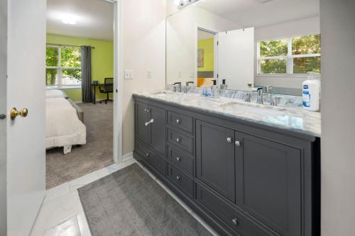 BelvidereにあるModern Comfort Loves Park - Stylish 3BR Getawayの洗面台と大きな鏡のあるバスルーム