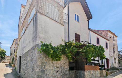 a building with a tree on the side of it at Stunning Apartment In Tkon With House Sea View in Tkon