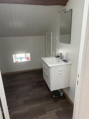 a bathroom with a white sink and a mirror at Maison familiale in Razès