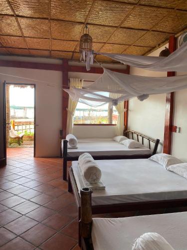 Ένα ή περισσότερα κρεβάτια σε δωμάτιο στο mekong riverside homestay