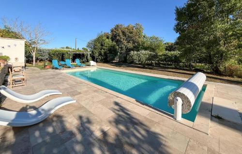 a swimming pool with a white and blue bench next to it at Awesome Home In Brignoles in Brignoles