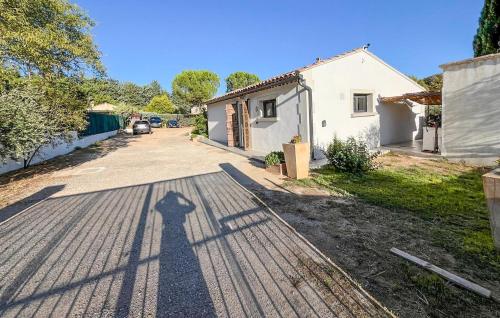 a shadow of a person standing on a driveway at Awesome Home In Brignoles in Brignoles
