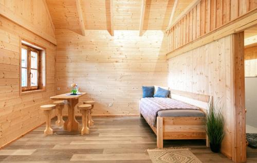a room with a bed and a table in a cabin at Chalet Mit Gemeinsamen Pool in Stainz