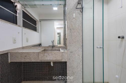 a bathroom with a sink and a mirror at Apto c/ Sefl Check-in na Asa Sul SQS0108 in Brasilia