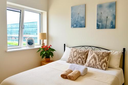 a bedroom with a bed with two towels on it at Heron Gate Comfort, Park and Pillow in Cork