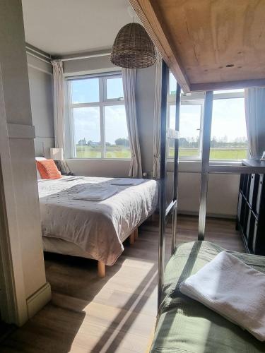 ein Schlafzimmer mit zwei Betten und einem großen Fenster in der Unterkunft The Old School House - Gaulverjaskoli in Selfoss