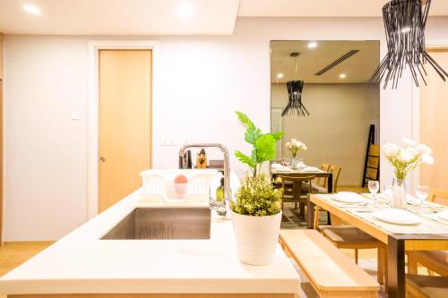 a kitchen with a sink and a dining table at 188 Suites by KidsCastle in Kuala Lumpur