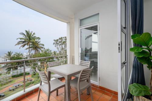 a balcony with a table and chairs and a view of the ocean at Chakas Cove in Ballito