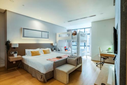 a bedroom with a bed and a desk and a chair at 188 Suites by KidsCastle in Kuala Lumpur