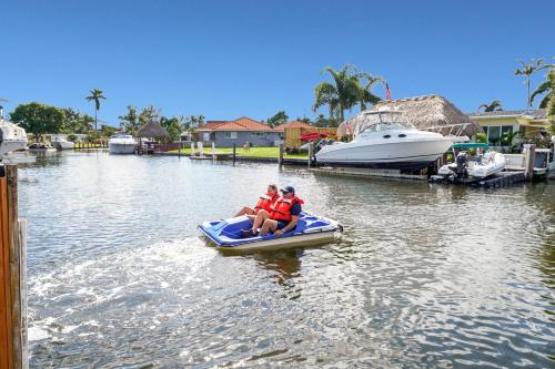 a group of people riding on a paddle boat in a canal at Waterfront Retreat Home Dania Beach in Dania Beach