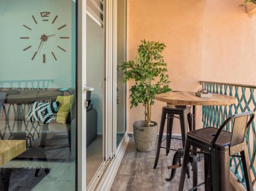 a room with a table and a clock on the wall at Alma in Caesarea
