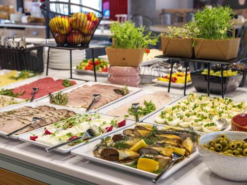 a buffet of different types of food on a table at ibis Styles Szczecin Stare Miasto in Szczecin