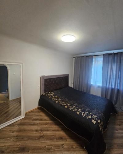 a bedroom with a bed and a window at Hercogs in Jelgava