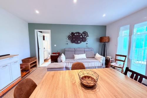 a living room with a table and a couch at Le Moorea - Apartment for 4 people in Hyères