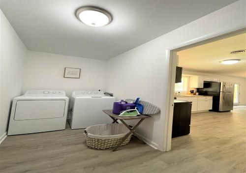 a laundry room with two washes and a table in it at The Hilltop in Center Point