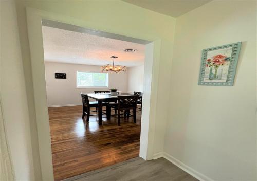 a dining room and living room with a table and chairs at The Hilltop in Center Point