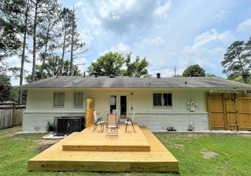 a backyard with a wooden deck in front of a house at The Hilltop in Center Point