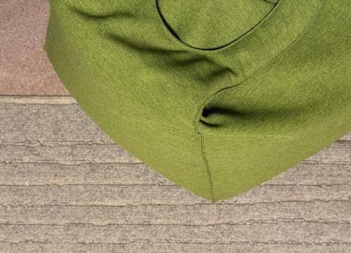 a green scarf sitting on top of a table at Ginevra Boutique Rooms - Palazzo Leosini - Residenze D'Epoca in LʼAquila