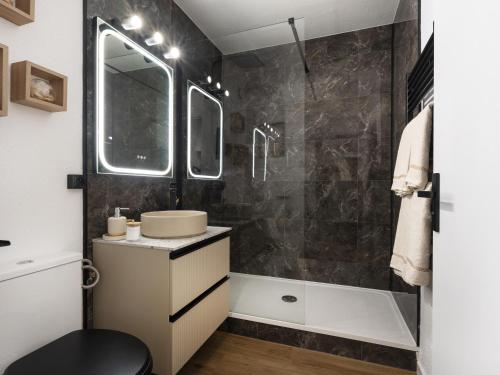 a bathroom with a sink and a shower at Le charme des bois in Amnéville