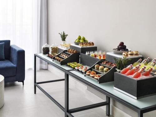 a buffet with different types of food on a table at Movenpick Jumeirah Village Triangle in Dubai