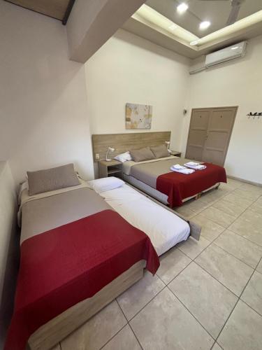 a bedroom with two beds in a room at Multiespacio Center in San Fernando del Valle de Catamarca
