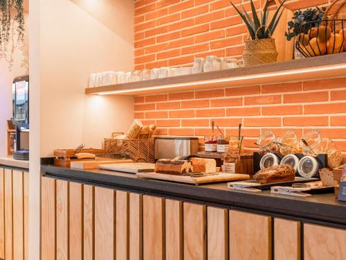 a bakery counter with bread and other items on it at ibis Styles Montauban in Montauban