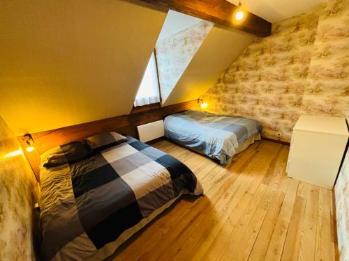 a bedroom with two beds in a attic at Chez Vincent Duplex 70 m2 3 ch Hypercentre in Luchon