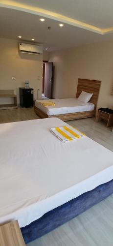 two beds in a room with two beds sidx sidx sidx at Hurghada Mirage Bay Hotel & Aquapark in Hurghada