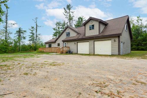 a house with a large driveway in front of it at Up North Getaway in Gaylord