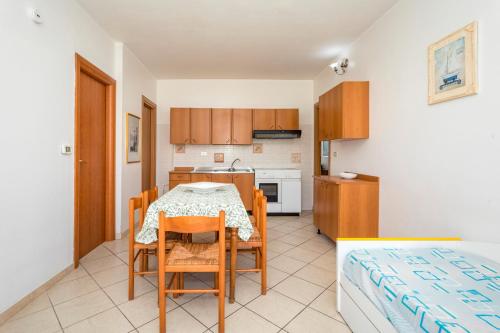 a kitchen and dining room with a table and chairs at I Ciottoli Dello Ionio in Mascali