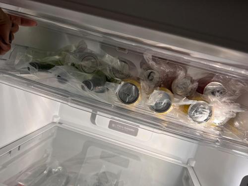 an open refrigerator filled with lots of food at House Amorim 13 min Parque peão in Barretos