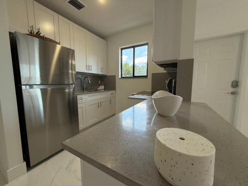 a large kitchen with a stainless steel refrigerator at Luxury apartment at excellent location, Breakfast and Parking in Miami