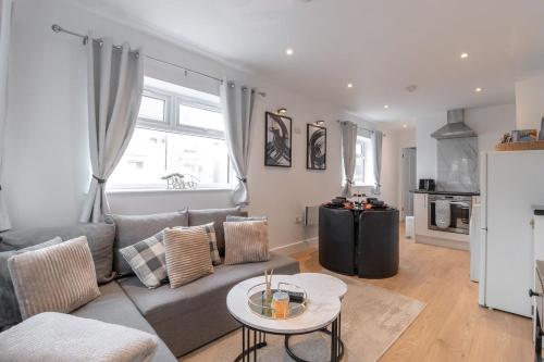 a living room with a couch and a table at Luxury 1 Bed Apartment Bromley in Bickley