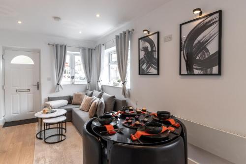 a living room with a couch and a table at Luxury 1 Bed Apartment Bromley in Bickley